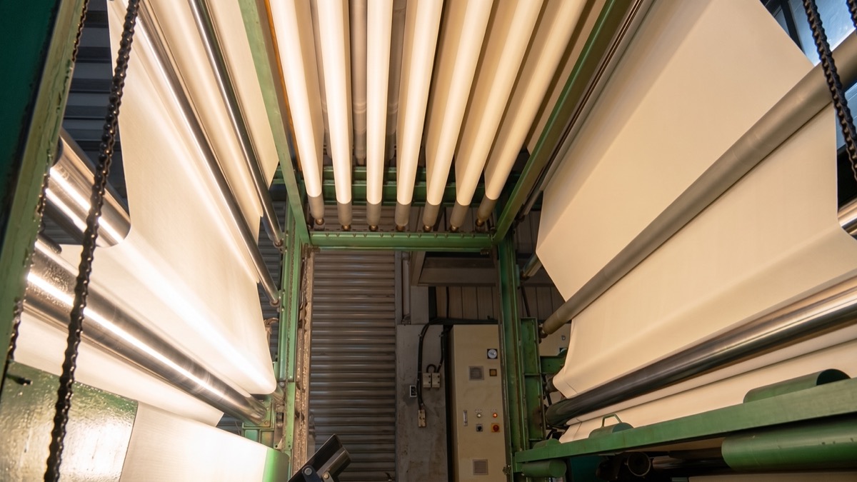 Wide-width fiberglass fabric running through lamination equipment